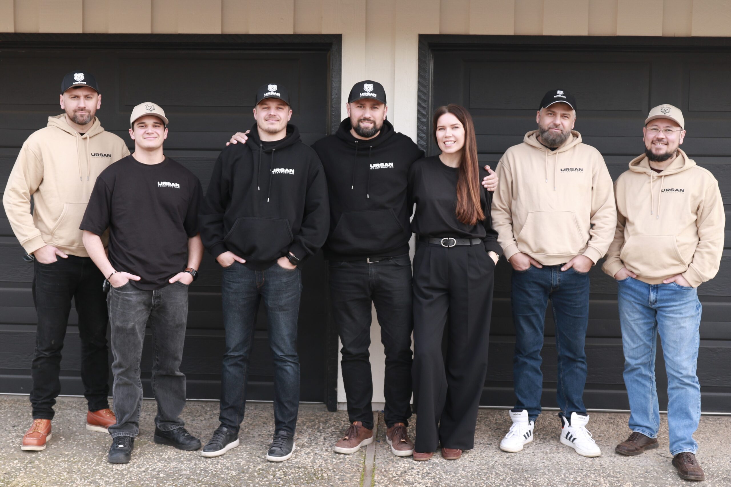 The expert remodeling team of Ursan Construction standing in front of a project.