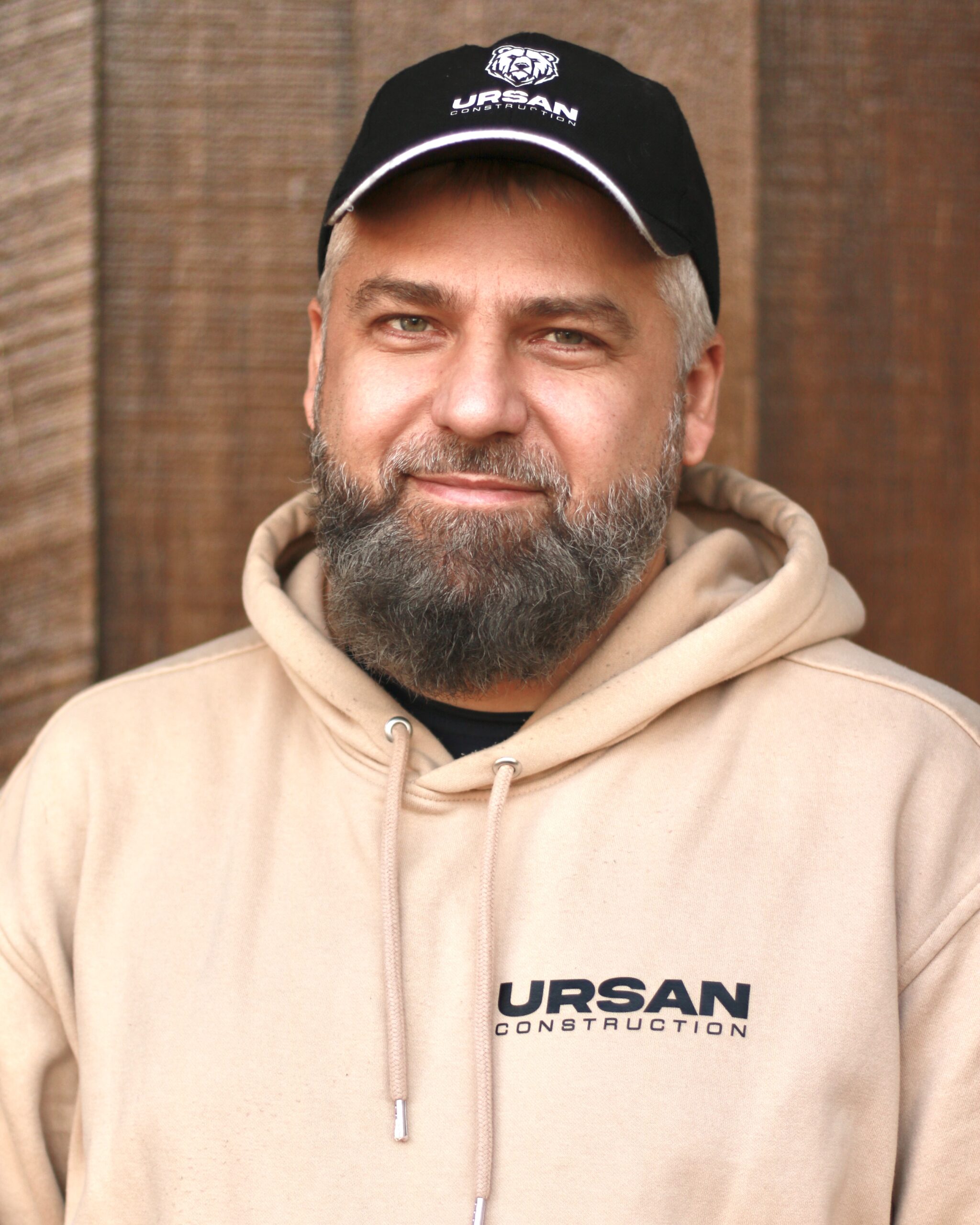Experienced remodeling contractor at Ursan Construction in team gear.