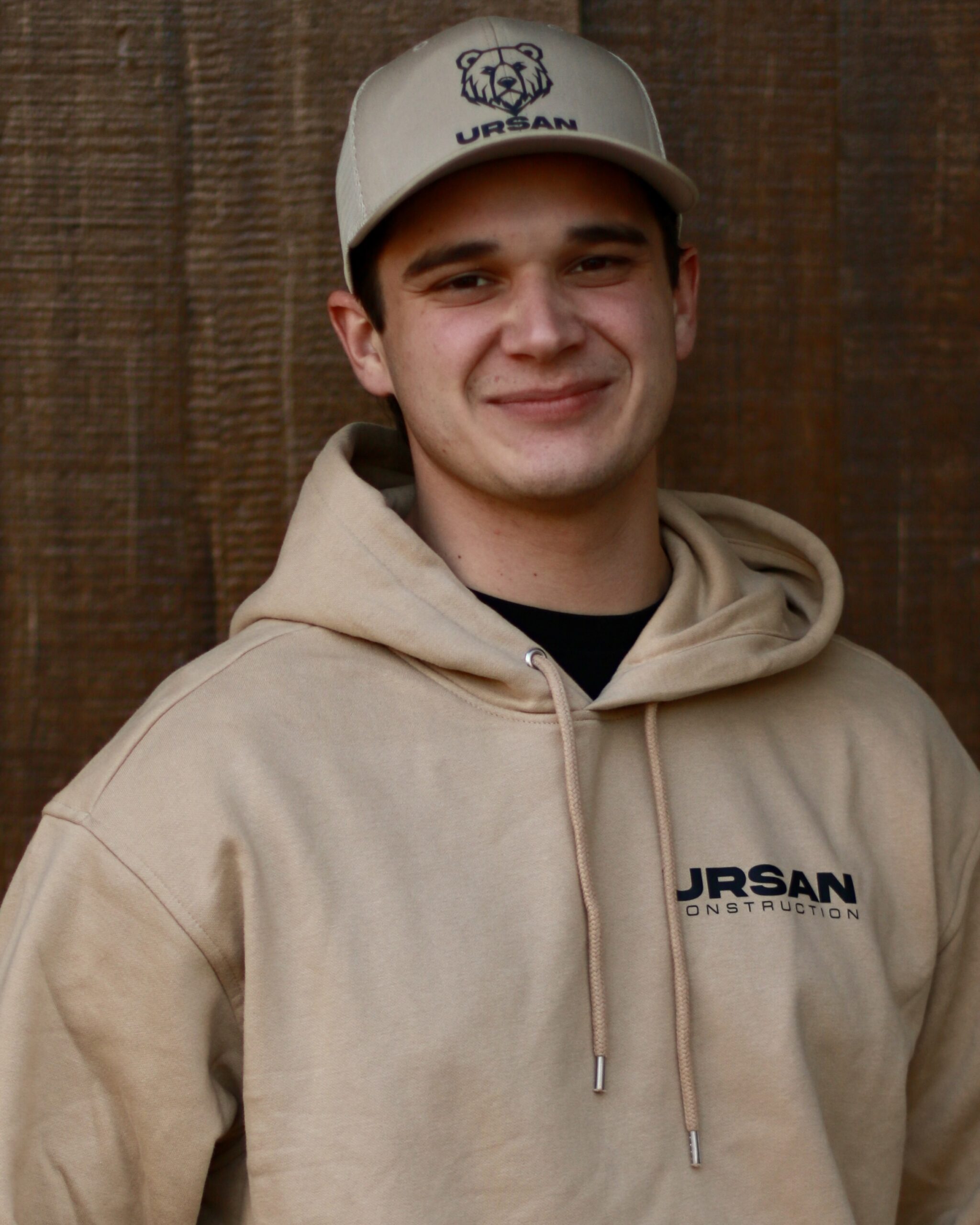 Skilled renovation specialist at Ursan Construction wearing a tan hoodie.